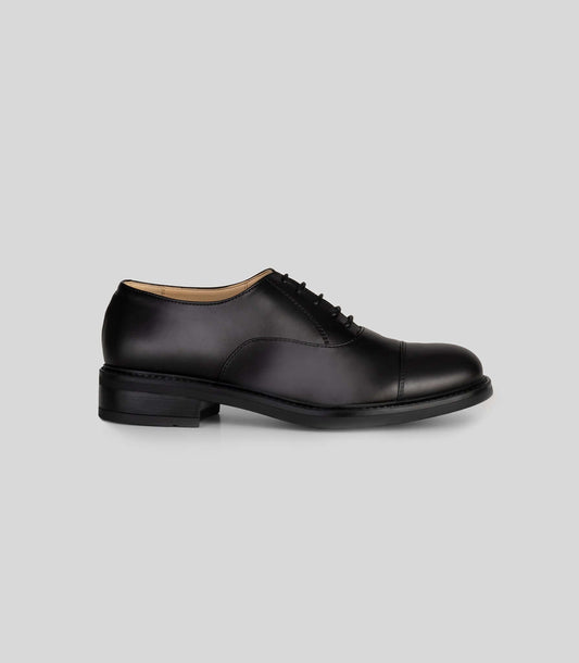 Vegan Oxford - Woman classic black lace-up shoe side view with Blake Construction.